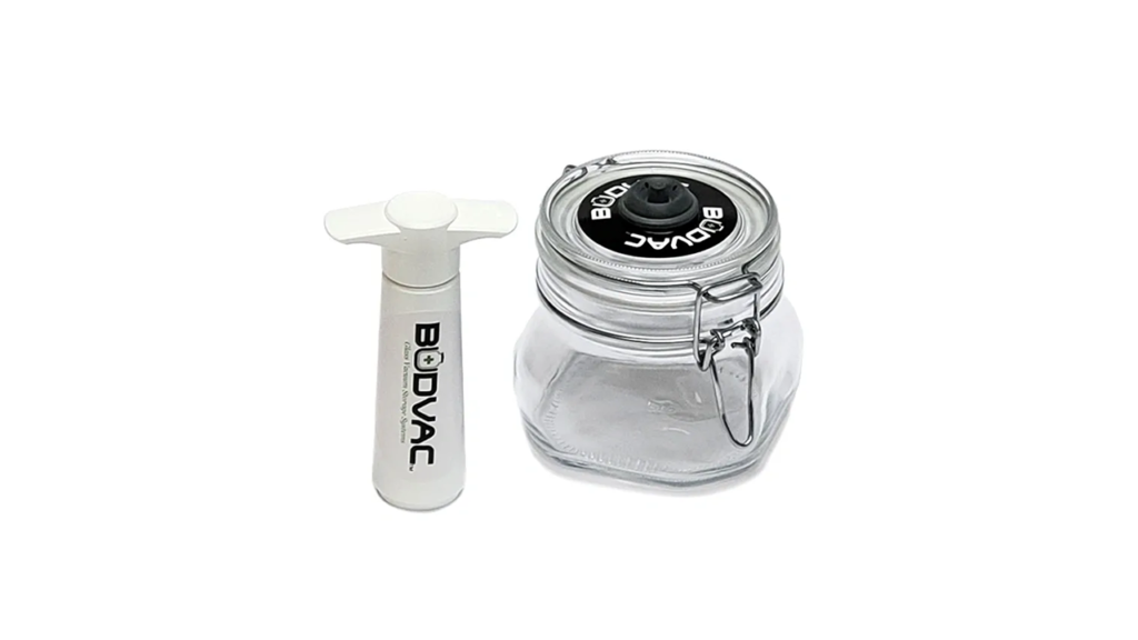 A jar and a razor blade are next to each other.
